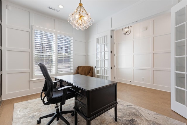 office featuring a notable chandelier and light hardwood / wood-style floors