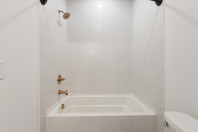 bathroom featuring toilet and tiled shower / bath combo