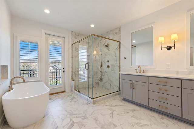 bathroom featuring vanity and separate shower and tub