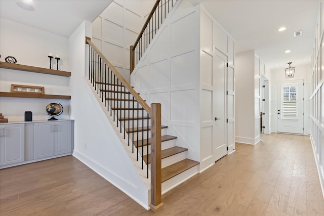 stairs featuring hardwood / wood-style flooring