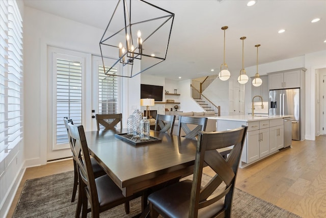 dining room with sink and light wood-type flooring