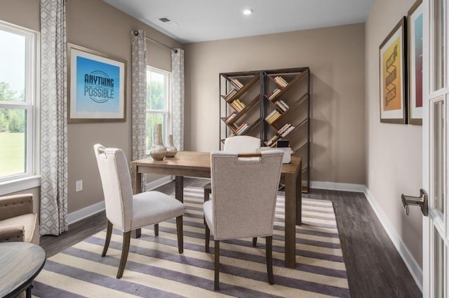 dining area with dark hardwood / wood-style flooring