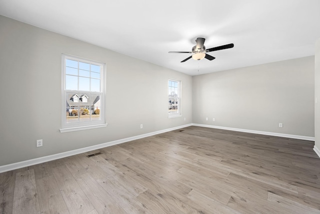 empty room featuring ceiling fan and light hardwood / wood-style flooring