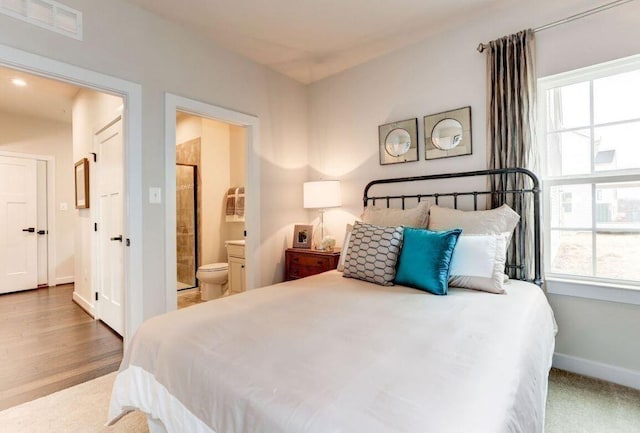 bedroom featuring wood-type flooring and ensuite bathroom