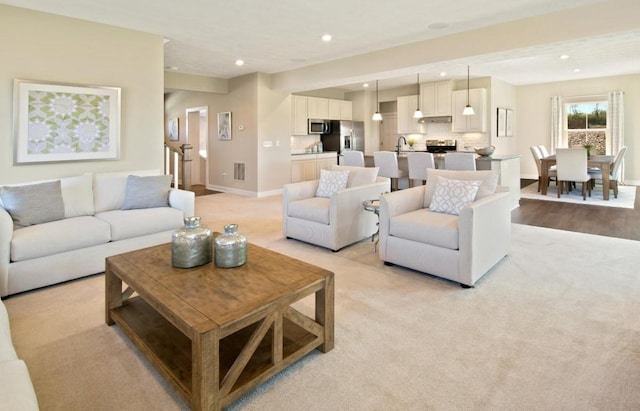 living room featuring light carpet