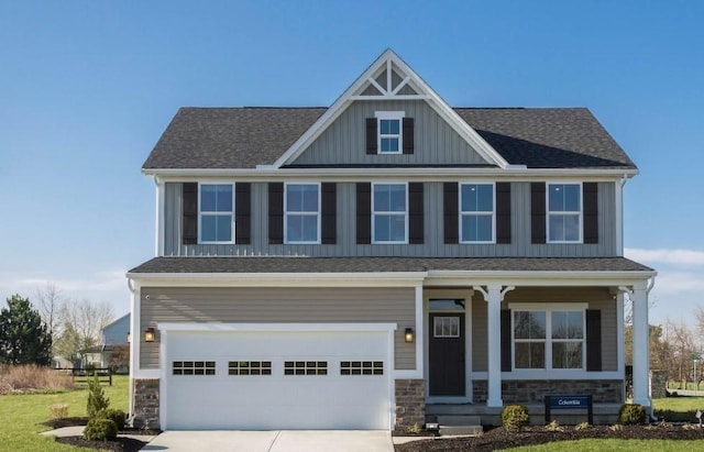 craftsman-style house featuring a garage and a front lawn