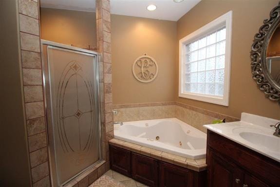 bathroom featuring vanity and shower with separate bathtub