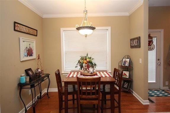 dining space with ornamental molding, dark hardwood / wood-style floors, and plenty of natural light