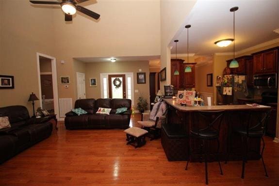 living room featuring ceiling fan and dark hardwood / wood-style flooring