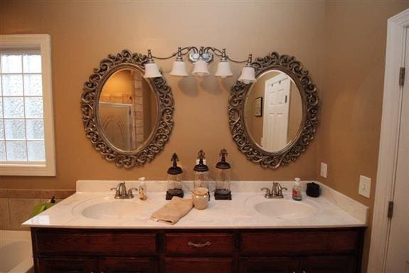 bathroom with vanity and a bathing tub