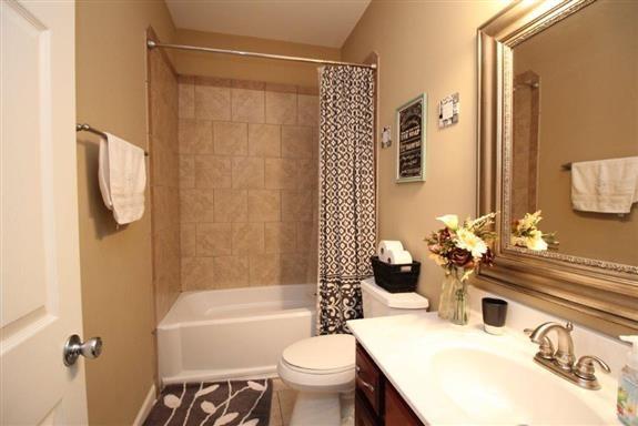 full bathroom featuring vanity, toilet, and shower / bath combo with shower curtain