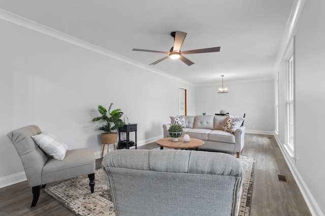 living room with ornamental molding, dark hardwood / wood-style floors, and ceiling fan