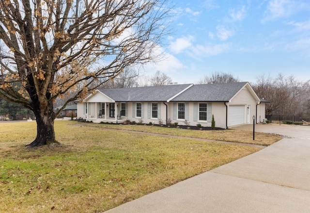 ranch-style home featuring a garage and a front yard