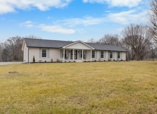 single story home with covered porch and a front yard