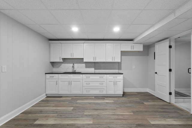 kitchen with white cabinetry, sink, and dark hardwood / wood-style floors