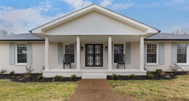 view of front of house with a front yard and a porch