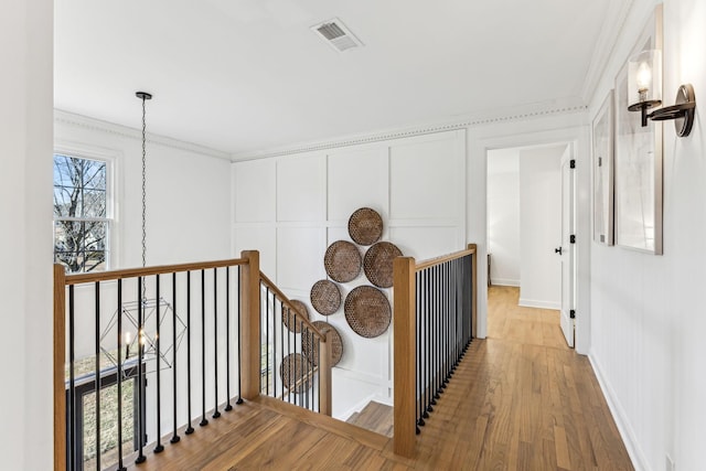 hall featuring hardwood / wood-style flooring and crown molding