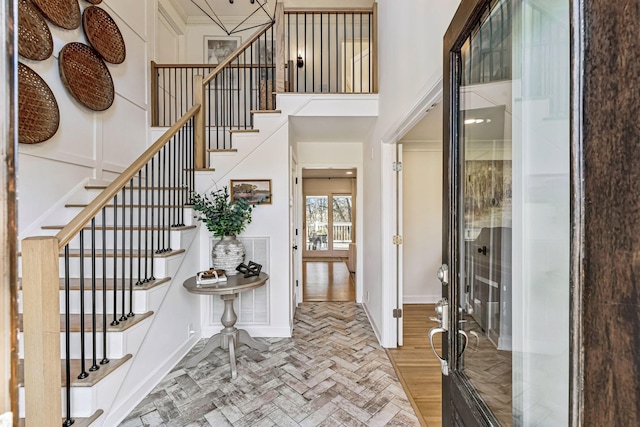 foyer entrance featuring a towering ceiling