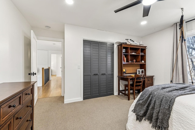 carpeted bedroom featuring ceiling fan and a closet