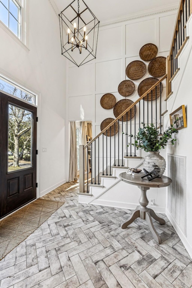 entrance foyer featuring a high ceiling and a notable chandelier