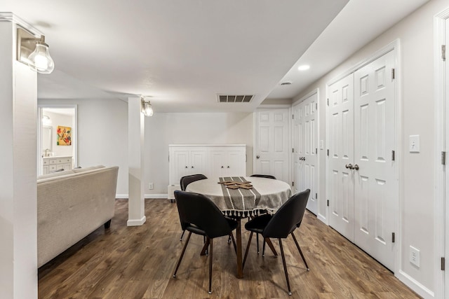 dining area featuring dark wood-type flooring