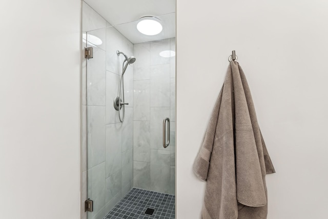 bathroom with a shower with shower door