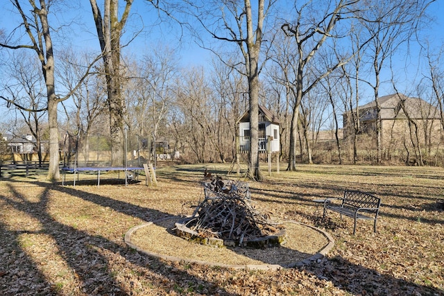 view of yard with a playground and a trampoline