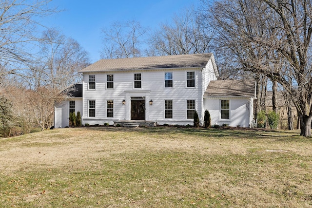 colonial inspired home featuring a front lawn