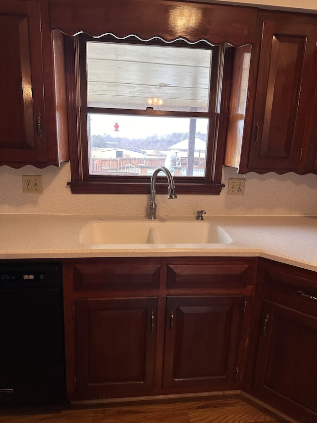 kitchen with dishwasher, sink, and dark brown cabinets