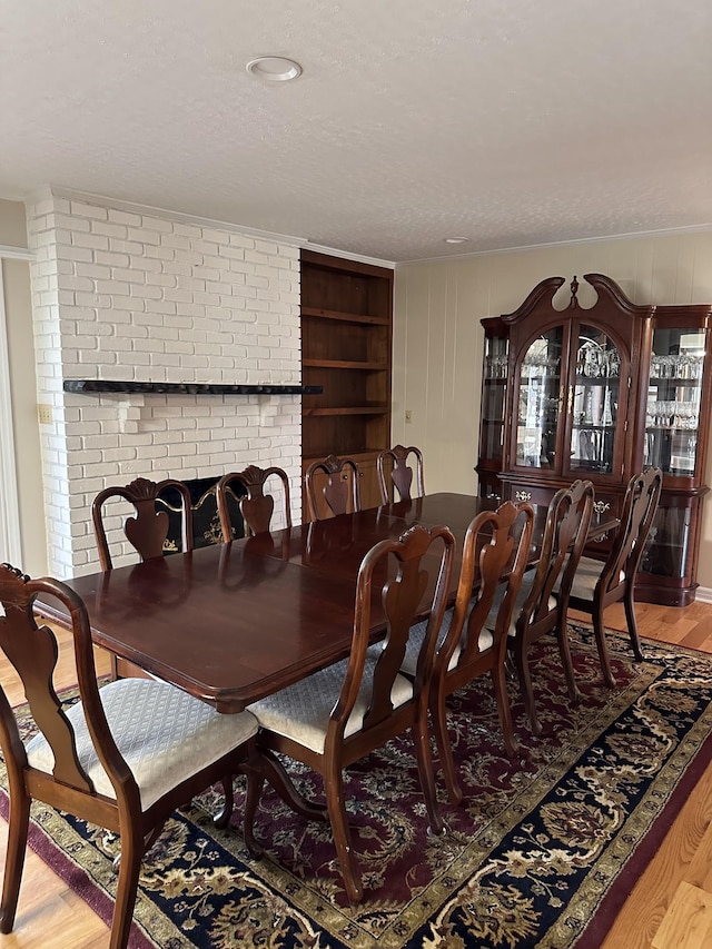 dining room with a textured ceiling and light hardwood / wood-style flooring