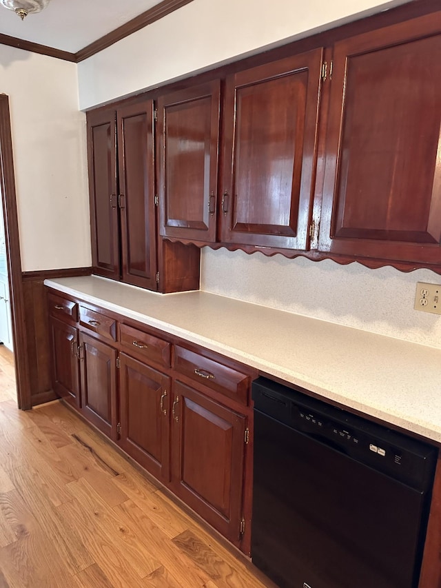 kitchen featuring light hardwood / wood-style flooring, ornamental molding, and black dishwasher