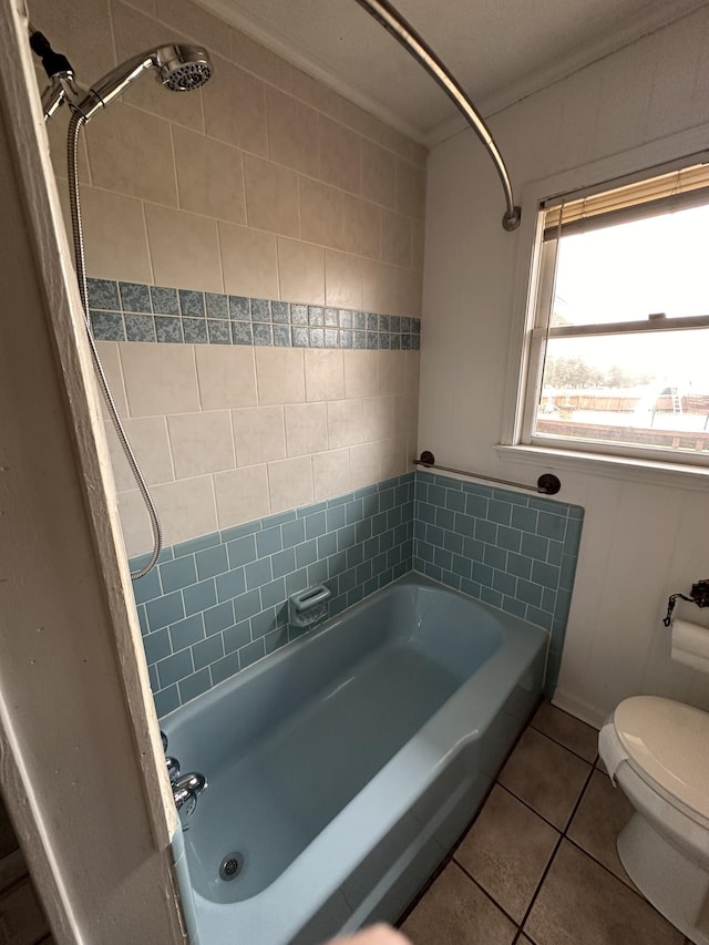 bathroom featuring shower / tub combination, tile patterned floors, and toilet