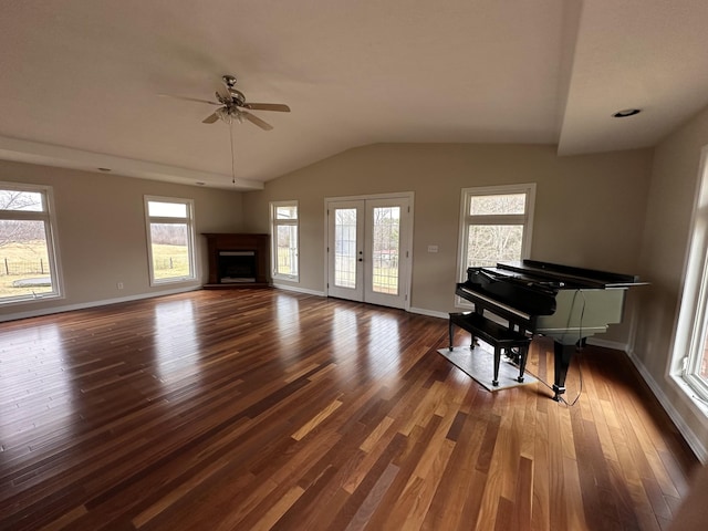 living room featuring lofted ceiling, dark hardwood / wood-style floors, and ceiling fan