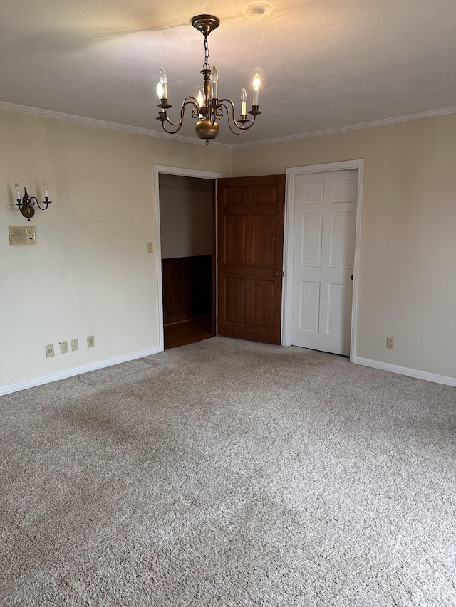 unfurnished bedroom featuring crown molding, carpet floors, and a notable chandelier