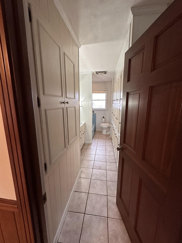 bathroom featuring vanity, tile patterned floors, toilet, and a textured ceiling