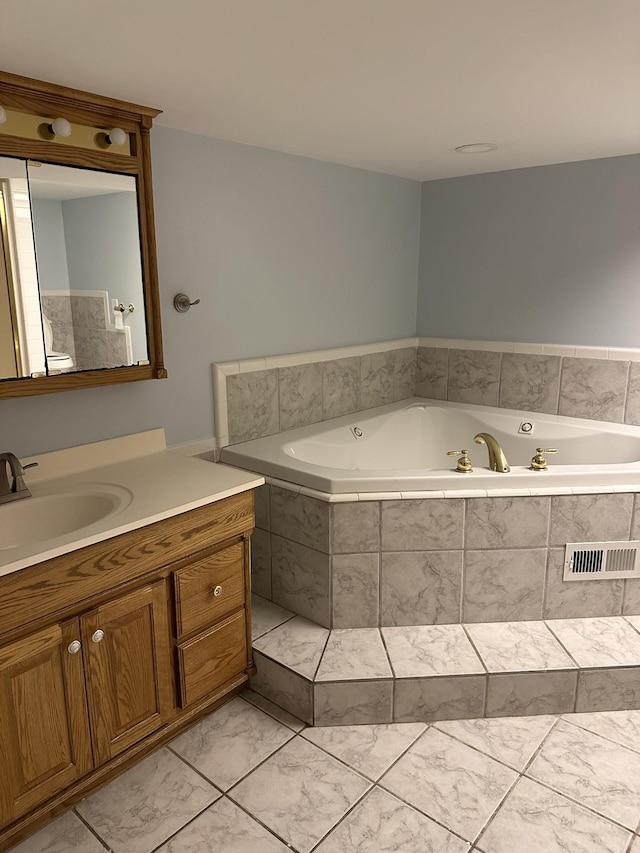 bathroom featuring vanity and tiled tub