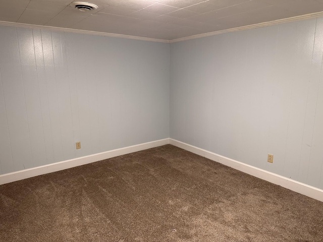 carpeted spare room featuring crown molding