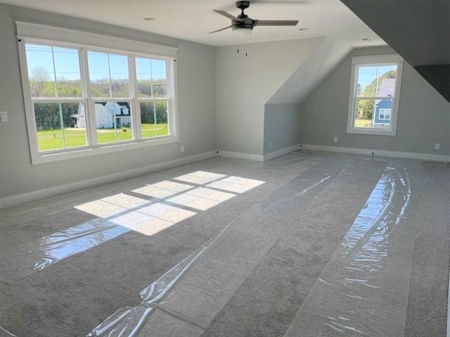 additional living space featuring ceiling fan