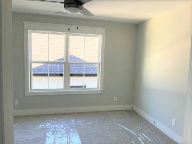 spare room with plenty of natural light and ceiling fan