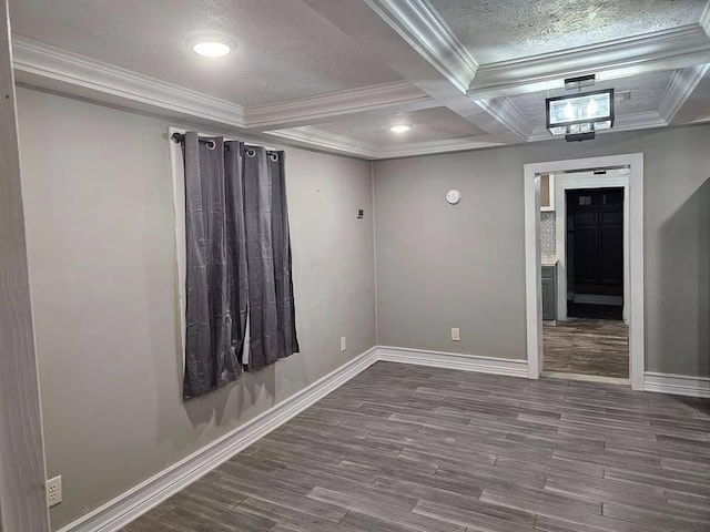 empty room with hardwood / wood-style flooring, crown molding, coffered ceiling, and beam ceiling