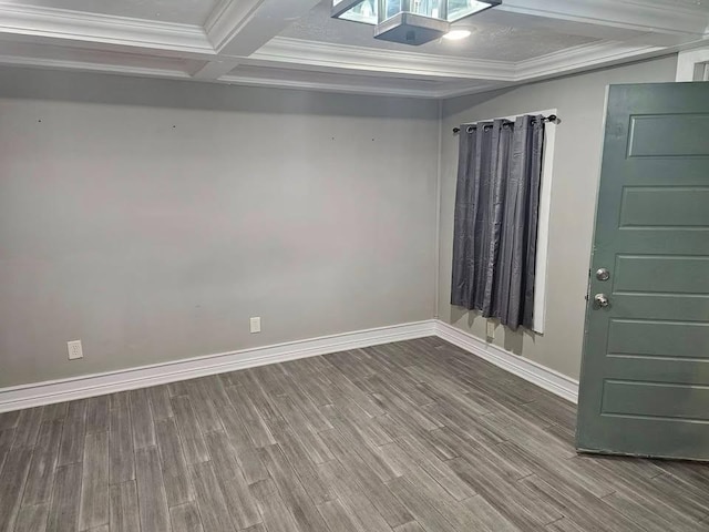 spare room with coffered ceiling, crown molding, wood-type flooring, and beam ceiling