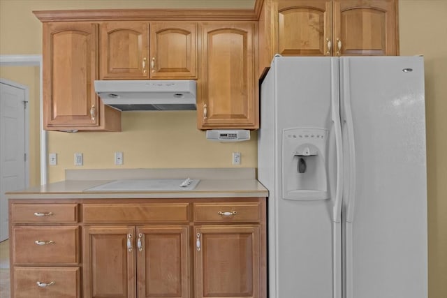 kitchen featuring white refrigerator with ice dispenser and stovetop