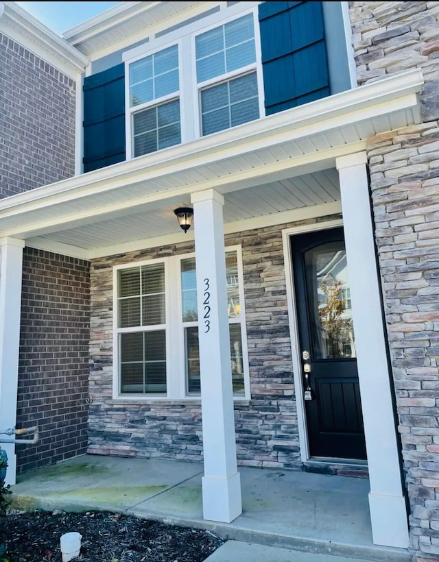 view of exterior entry with covered porch