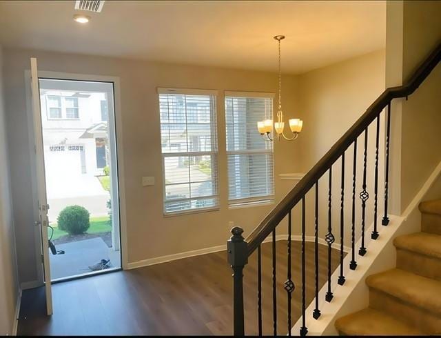 interior space with hardwood / wood-style flooring, plenty of natural light, and a chandelier