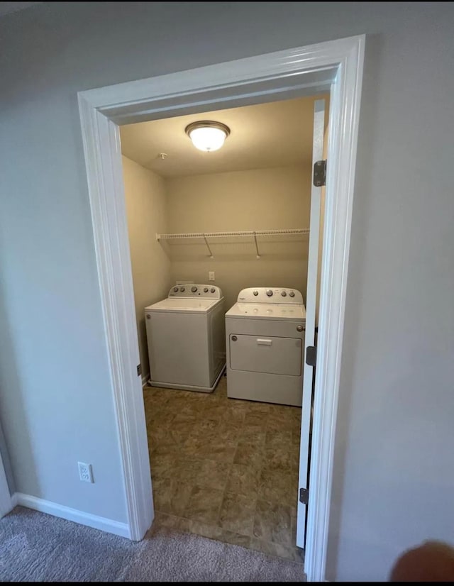 washroom with washing machine and clothes dryer