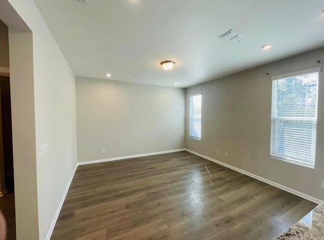 unfurnished room featuring dark wood-type flooring