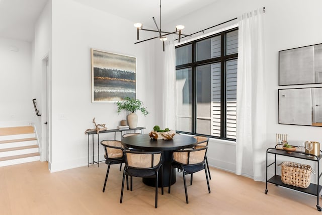 dining room featuring a notable chandelier and light hardwood / wood-style flooring