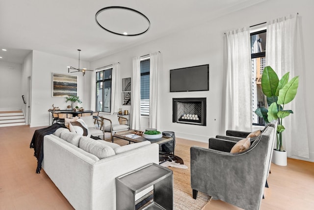 living room featuring an inviting chandelier and light hardwood / wood-style flooring