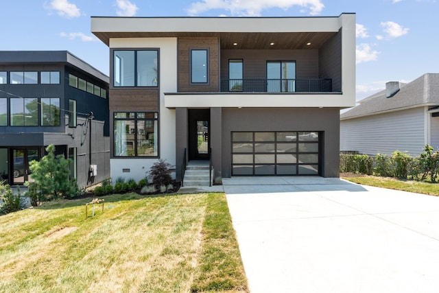 contemporary home with a garage and a front yard