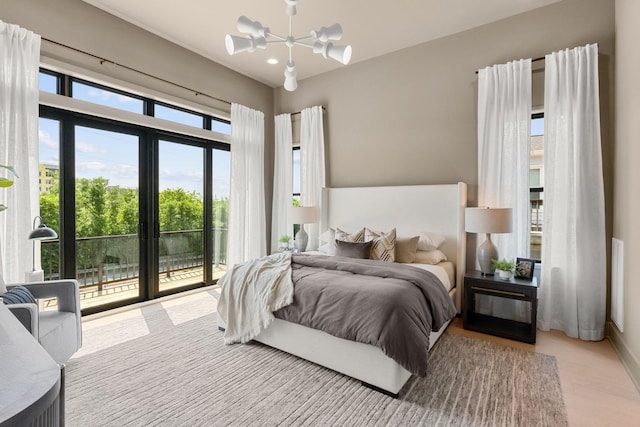 bedroom with an inviting chandelier and access to outside